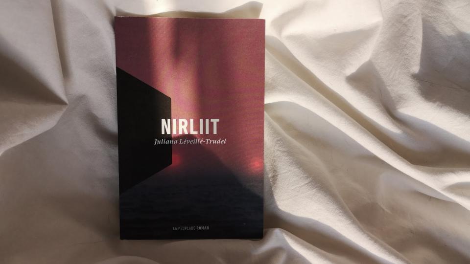 Couverture de l'ouvrage "Nirliit" de Juliana Léveillé-Trudel. L'ouvrage est rouge et évoque le paysage à la fois désertique et montagneux de la région arctique du Canada par la montagne en son centre. Rien d'autre ne l'entoure.